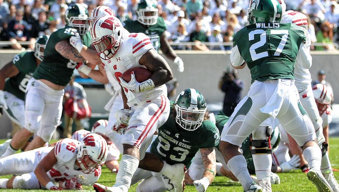 Wisconsin Badgers running back Corey Clement (6) scores a touchdown against Michigan State Spartans linebacker Chris Frey (23) during the first quarter of a game at Spartan Stadium.
