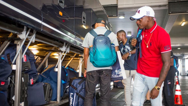 U.S. sprinter Trayvon Bromell (in red) arrives to Houston Bush Intercontinental for a United Airlines flight to Rio de Janeiro on Aug. 3, 2016.