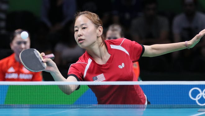 Jiaqi Zheng of the U.S.lines up a shot against Germany during the first round of women's team table tennis action. Germany won 3-0.