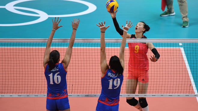 Changning Zhang of China hits the ball against Tijana Boskovic of Serbia during a women's team volleyball preliminary round game in the Rio 2016 Summer Olympic Games at Maracanazinho.