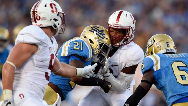 Stanford Cardinal wide receiver Francis Owusu (6) is hit by UCLA Bruins wide receiver Mossi Johnson (21) and fumbles the ball during the first half at Rose Bowl.