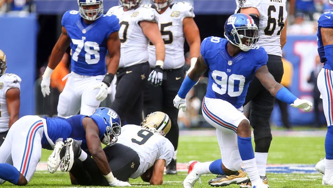 New York Giants defensive end Jason Pierre-Paul (90) celebrates a sack of New Orleans Saints quarterback Drew Brees (9) during the first half at MetLife Stadium.