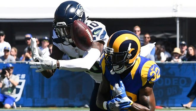 Rams defender Troy Hill (32) breaks up a pass intended for Seahawks receiver Paul Richardson (10) during the first half.