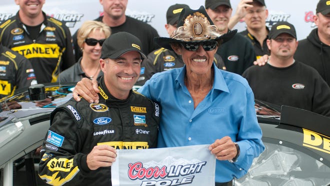 Richard Petty poses with driver Marcos Ambrose after Ambrose won the pole at Sonoma Raceway in 2012 for Richard Petty Motorsports.