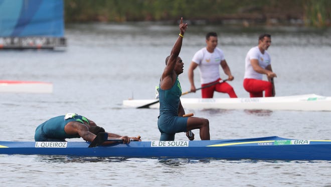 Erlon De Souza Silva and Isaquias Queiroz Dos Santos of Brazil celebrate after finishing second in the men's canoe double (C2) 1000m final during the Rio 2016 Summer Olympic Games at Lagoa Stadium.