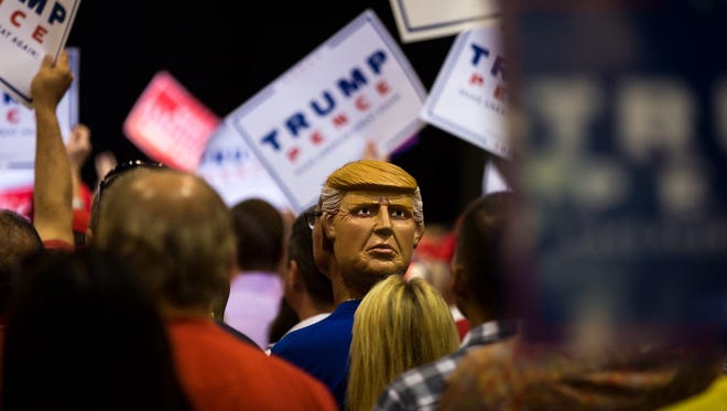A man wears a Donald Trump mask backwards in Tampa on Aug. 24, 2016.