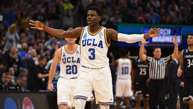 UCLA guard Aaron Holiday (3) celebrates a three-point basket against Cincinnati.