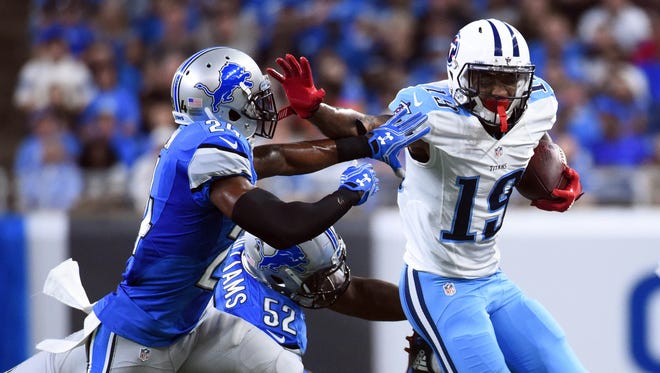 Tennessee Titans wide receiver Tajae Sharpe (19) runs the ball against Detroit Lions cornerback Nevin Lawson (24) and linebacker Antwione Williams (52) during the second quarter at Ford Field.