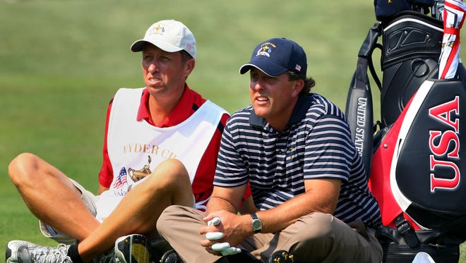 Phil Mickelson waits in a fairway with his caddie Jim Mackay during the afternoon four-ball matches on day two of the 2008 Ryder Cup at Valhalla Golf Club on  in Louisville.