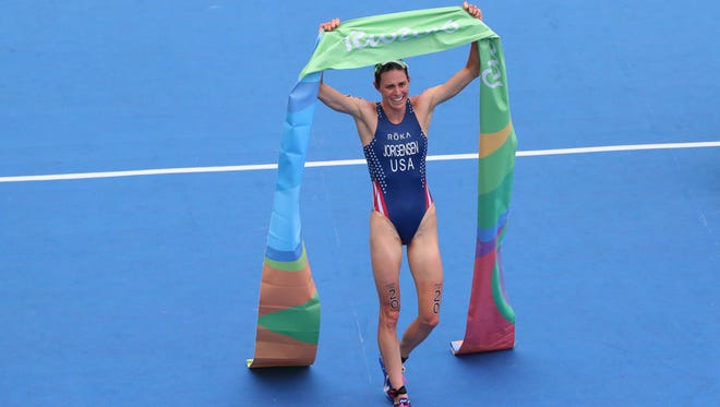 Gwen Jorgensen of the United States celebrates after winning gold in the women's triathlon during the Rio 2016 Summer Olympic Games at Fort Copacabana.