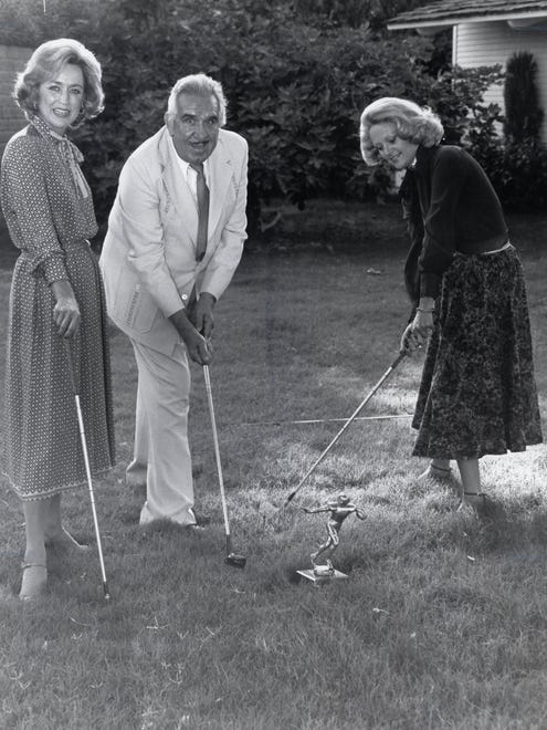 Nelda Linsk, Tony Capps and Barbara Sinatra pose to publicize a local golf tournament.