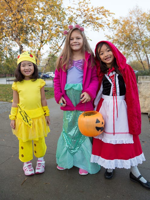 Haruka Mazushima, 4, (from left) Sasha Kosokina, 7, nad Niku Mazushima, 7, all of West Des Moines, wear costumes Friday, Oct. 23, 2015, during Halloween Hoopla at Raccoon River Park in West Des Moines.