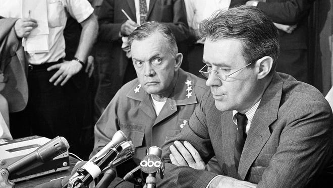 Lt. Gen. John J. Throckmorton, left, commanding general of U.S. Army troops in Detroit, and Cyrus Vance, special assistant to Defense Secretary Robert McNamara, appear at a press conference in Detroit, July 25, 1967. Vance said the situation in the city appeared less tense than the previous night. Gen. Throckmorton said his troops had been ordered to use minimum force to keep order in the riot areas.