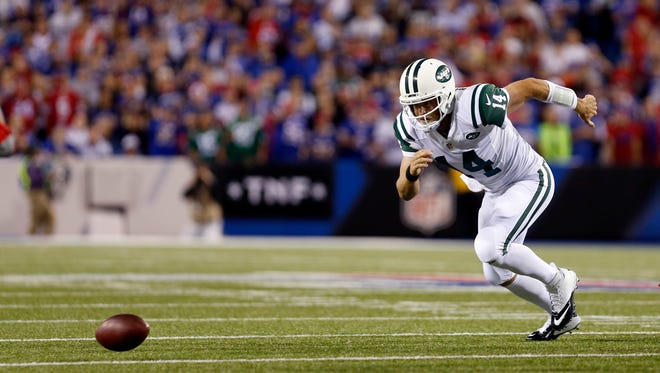 New York Jets quarterback Ryan Fitzpatrick (14) fumbles the snap during the first half against the Buffalo Bills at New Era Field.