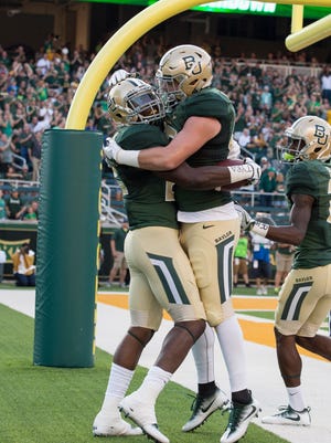 Baylor Bears running back Terence Williams (22) and tight end Jordan Feuerbacher (85) celebrate a touchdown.