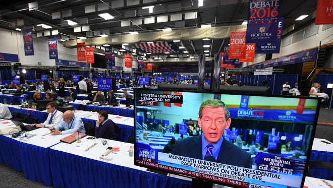 Reporters work next door to the debate hall ahead of the first presidential debate between Hillary Clinton and Donald Trump at Hofstra University.