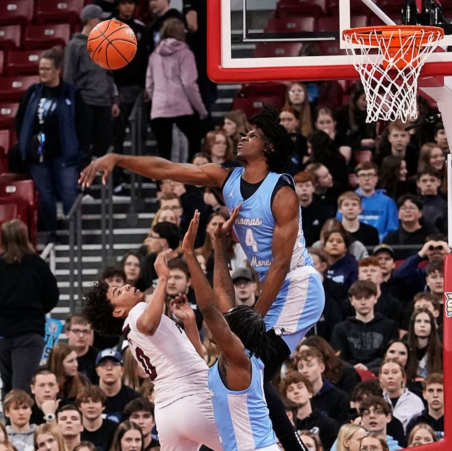 St. Thomas More's Amari McCottry (4) blocks the shot from Prescott's Kobe Russell (0) during the first half of the WIAA Division 3 boys basketball state semifinal game on Thursday March 14, 2024 at the Kohl Center in Madison, Wis.