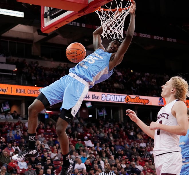 St. Thomas More's Sekou Konneh (25) dunks during the second half of the WIAA Division 3 boys basketball state semifinal game against Prescott on Thursday March 14, 2024 at the Kohl Center in Madison, Wis.