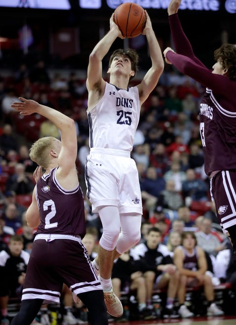Columbus Catholic High School's Cy Becker (25) against Solon Springs High School's guard Dylan Taggart (2) and forward Kaden Corlett (13) in a Division 5 semifinal game during the WIAA state boys basketball tournament on Friday, March 15, 2024 at the Kohl Center in Madison, Wis.
Wm. Glasheen USA TODAY NETWORK-Wisconsin