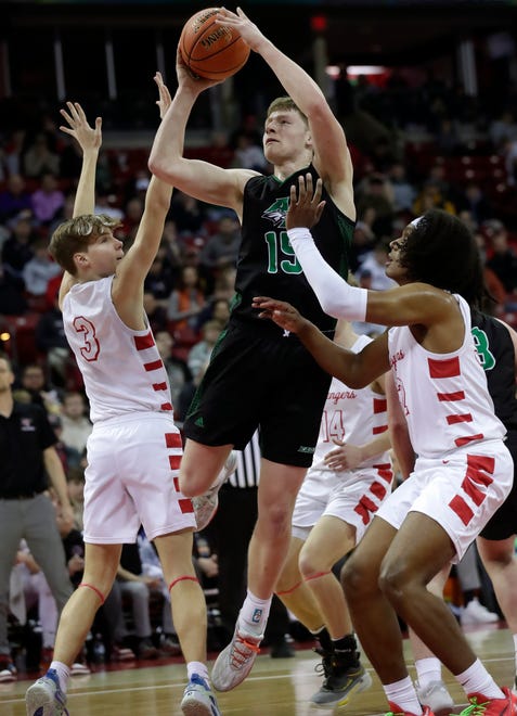 Almond-Bancroft High School's Ayden Phillips (15) against Abundant Life Christian School's Jimmitrius Davison (32) and Jonah Koon (3) in a Division 5 semifinal game during the WIAA state boys basketball tournament on Friday, March 15, 2024 at the Kohl Center in Madison, Wis.
Wm. Glasheen USA TODAY NETWORK-Wisconsin