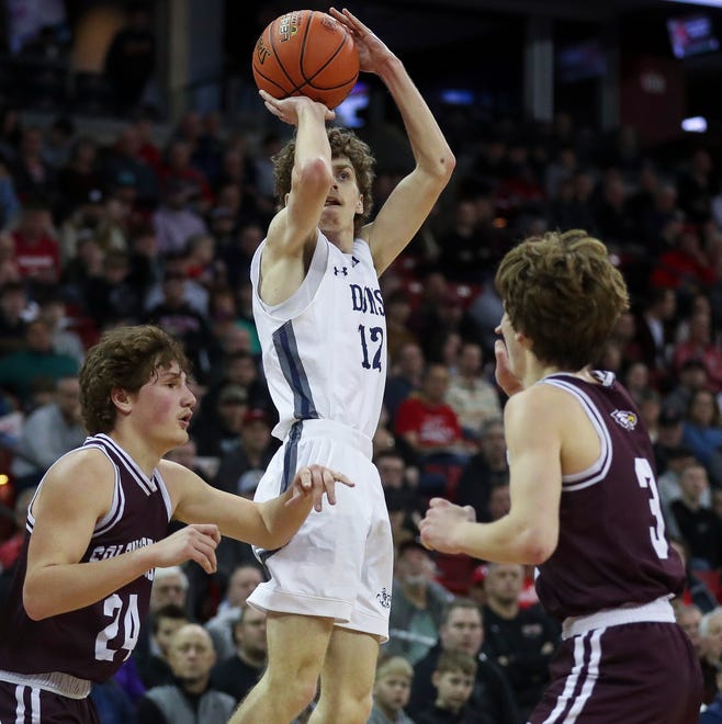 Columbus Catholic High School's Charlie Moore (12) shoots the ball against Solon Springs High School in a Division 5 semifinal game during the WIAA state boys basketball tournament on Friday, March 15, 2024 at the Kohl Center in Madison, Wis. Columbus Catholic won the game, 78-65.