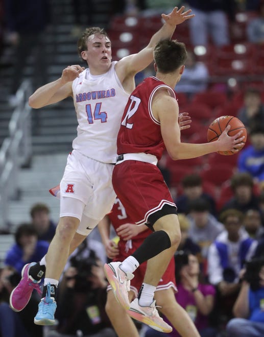 Arrowhead High School's Bennett Basich (14) against Neenah High School's Brady Corso (12) in a Division 1 semifinal game during the WIAA state boys basketball tournament on Friday, March 15, 2024 at the Kohl Center in Madison, Wis. Arrowhead defeated Neenah for 99-95 in four overtimes.
Wm. Glasheen USA TODAY NETWORK-Wisconsin