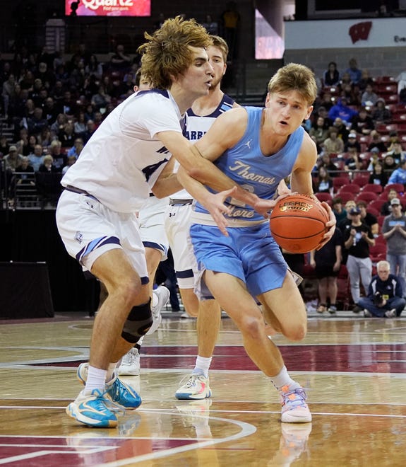Lakeside Lutheran's Evan Neumann (4) guards St. Thomas More's Evan Oleson (2) during the second half of the WIAA Division 3 boys basketball state championship game on Saturday March 16, 2024 at the Kohl Center in Madison, Wis.