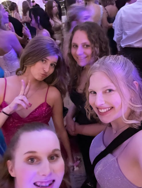 Josie Hart (front), Abbie Hart (right), Breanna Borel (left) and Myrinda Springer take a selfie on the dance floor at Hortonville High School's prom on Saturday, April 13, 2024.