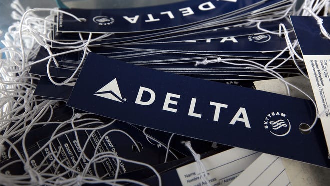 Delta luggage tags sit in a basket at a skycap kiosk at San Francisco International Airport on Jan. 12, 2010.