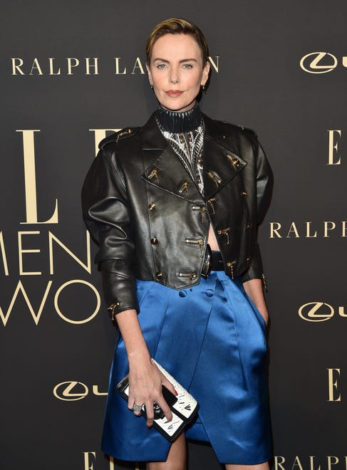 Rock on, Charlize! She ' s giving off major punk vibes with her slicked-back hair and Louis Vuitton leather jacket at the 2019 Elle Women in Hollywood event. Theron added a pop of color with her cobalt blue Vuitton skirt.