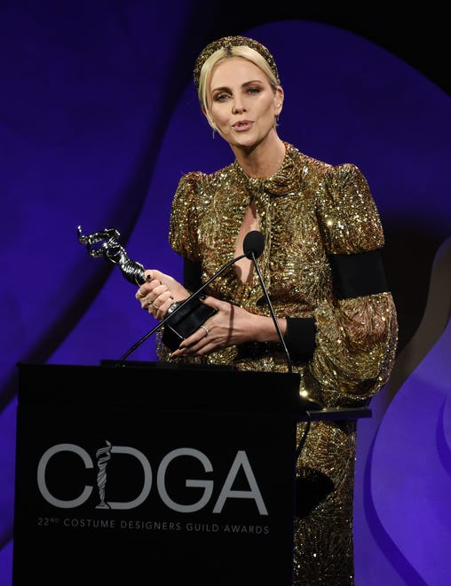 Theron is dazzling with her Spotlight Award at the 22nd annual Costume Designers Guild Awards. She wore a gold Louis Vuitton keyhole dress with a matching headband.