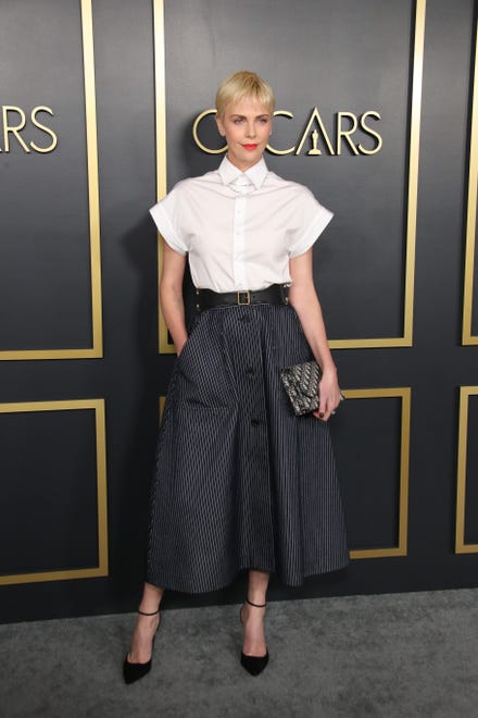 She ' s ditching the gowns for a business casual look, pairing a chic white shirt with pinstripes on bottom at the Nominees Luncheon for the 92nd Oscars in 2020.