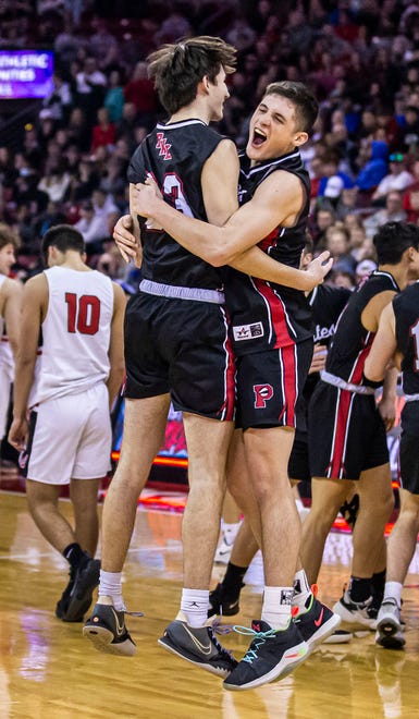 Pewaukee's Nick Leffler, left, and Nick Janowski celebrate the team's second consecutive WIAA Division 2 boys basketball state championship after defeating La Crosse Central, 67-48, at the Kohl Center in Madison on Saturday, March 19, 2022.