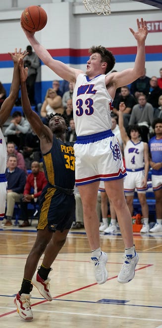 Wisconsin Lutheran guard Kon Knueppel (33) out rebounds  Pius XI’s Can Joseph (33) during their game Thursday, December 8, 2022 at Wisconsin Lutheran High School in Milwaukee, Wis.