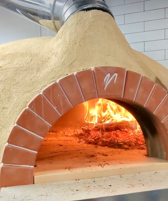 A wood-fired oven quickly bakes the pizzas at Maggio's Wood Fired Pizza, 7212 W. North Ave. in Wauwatosa, which officially opened Feb. 8. The restaurant serves Neopolitan-like pizzas in the former site of Tosa Bowl and Bun.